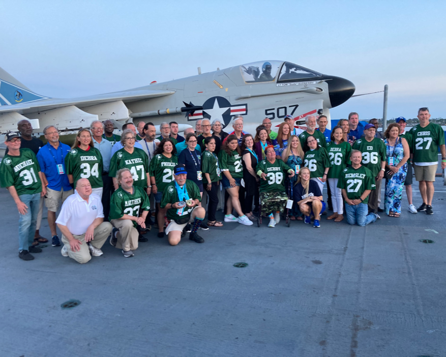 transplant games participants in front of airplane