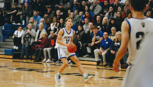Cooper Boike, 17, of Flint, Mich. on the basketball court after his first cornea transplant.