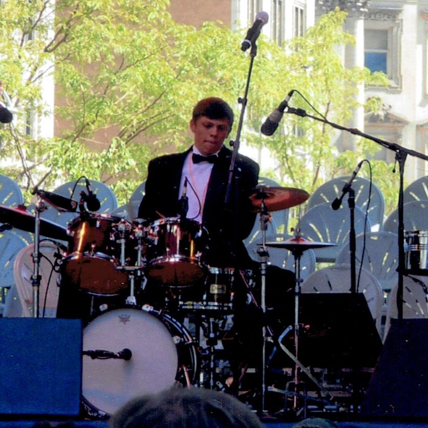 Boy playing the drums on stage
