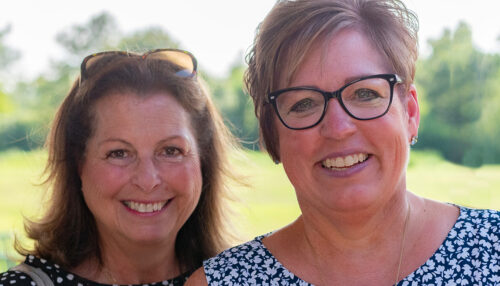 Two women smiling outside
